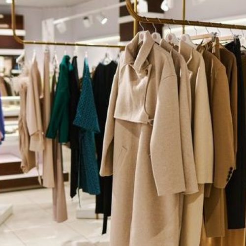 Wide angle background image of Autumn fashion collection on racks
